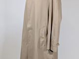 an image of a coat on a mannequin stand with a white background
