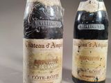 two bottles of wine sitting next to each other on a table