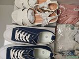two pairs of shoes in a box on a table