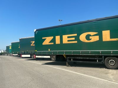 a lot of trucks that are parked on the side of the road