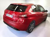 the rear end of a red car in a white room