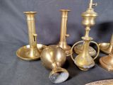 five different types of brass candles on a table