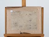 painting on easel with a piece of paper on top of it