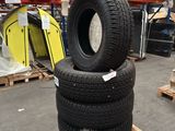 tires stacked on pallets in a warehouse with pallets in the background