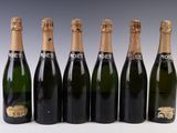 six bottles of champagne are lined up in a row