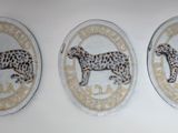 three oval shaped magnets with animal designs on them on a wall