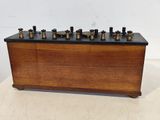 an old wooden box with six bottles of liquor on top of it