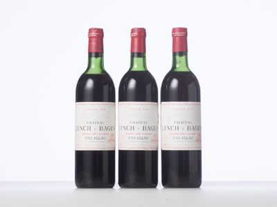 three bottles of red wine sitting next to each other on a table