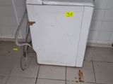 a small white refrigerator in the corner of a room
