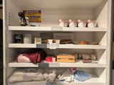 many items on the shelves in the cabinet