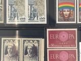 a lot of stamps that are on display in a case