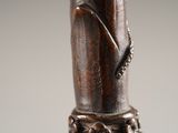a close up of a statue of a person holding a cane