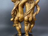 pair of antique bronze figurines of a boy and a girl