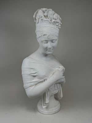 white marble bust of a woman with a turban on her head