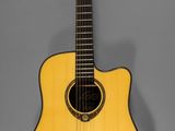 a yellow acoustic guitar hanging on a gray wall