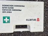 a white box with a red cross on it sitting on the ground