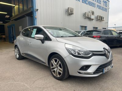the silver car is parked in front of a building
