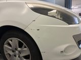 a close up of a white car in a garage