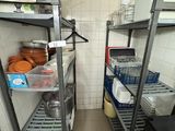 many shelves in the kitchen with dishes on them