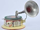 a silver and red gramphone on top of a yellow and red stand