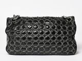 a black crocodile skin clutch bag on a white background