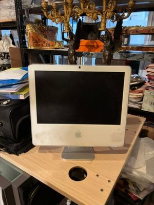un écran d'ordinateur posé sur un bureau en bois