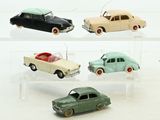 four toy cars that are sitting on a clear shelf