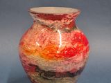 a vase with a red, yellow, and green design on it