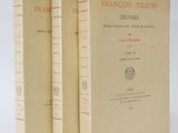 two books sitting on top of each other on a white surface