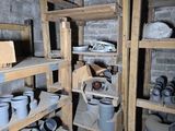 many pots and pans on the shelves in the room
