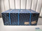 a box that is sitting on a chair with a tag on it