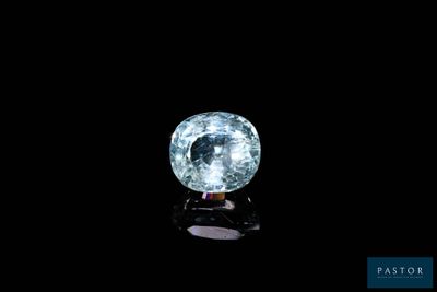 a close up of a blue diamond on a black surface