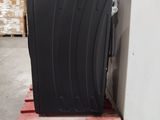a black piece of luggage sitting on a pallet in a warehouse
