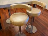 three stools that are sitting on a table in the kitchen
