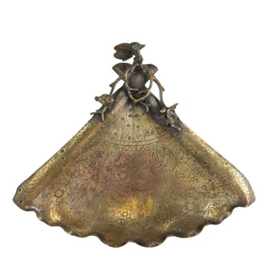 an image of a gold plate with a woman on it