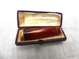 a small box with a pen inside of it