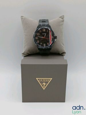 a watch sitting on top of a box with a pillow