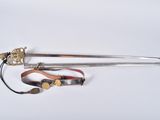 an image of a sword and other items on a white surface