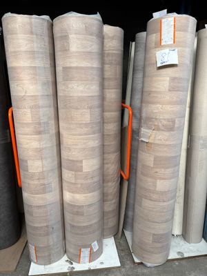 several rolls of paper stacked on top of each other in a warehouse