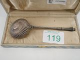 an antique silver spoon in a box with a price tag on it