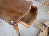 a wooden desk with a drawer underneath it