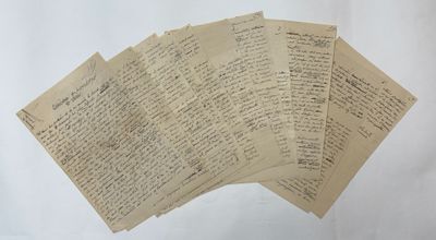 several old papers are stacked on top of each other on a table