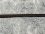 a close up of a metal object on a marble surface