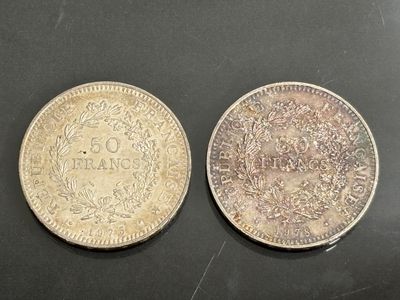 deux pièces, l'une en argent et l'autre en argent, posées sur une surface noire