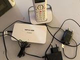 a cell phone that is connected to a charger on a table