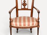 a wooden chair with a striped upholstered seat and arms