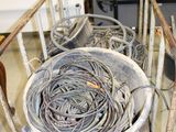 a lot of wires that are on a cart in the room