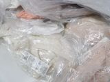 a pile of stuffed animals in plastic bags on a table