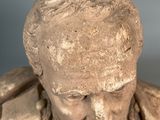 a statue of a man with a beard and a collar