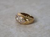 yellow gold ring with diamonds on a marble surface